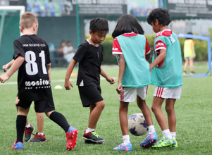 Kids playing soccer on field